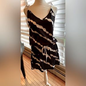 This adorable beach cover up has drawstring waist and tied shoulders.size small